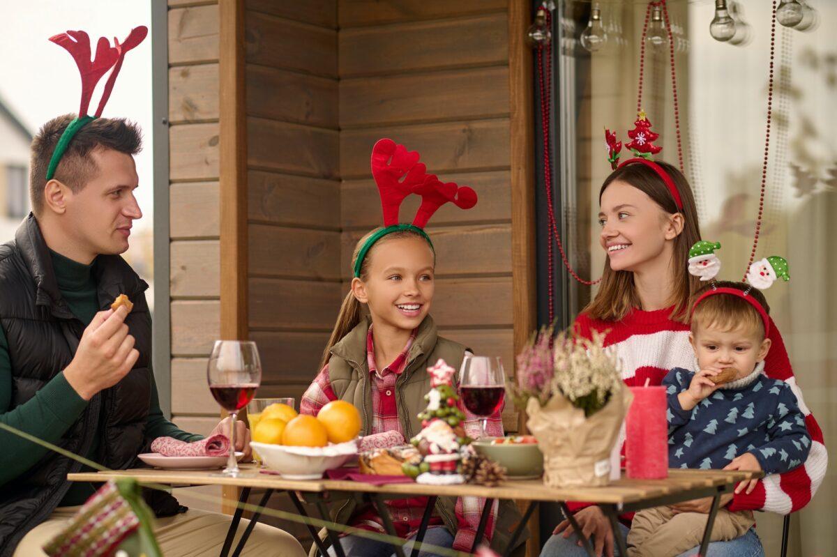 A happy family sitting at the table and celebrating christmas